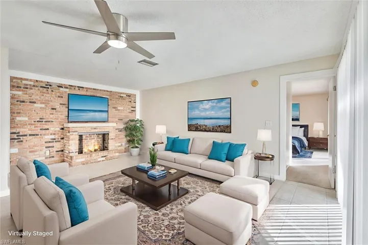 Virtually Staged Living area with a fireplace, a ceiling fan, and brick wall