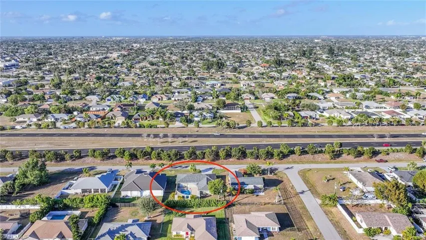 Aerial overview of property's location with nearby suburban area