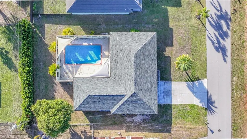 View of subject property with a pool area
