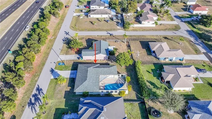 Aerial overview of property's location featuring nearby suburban area