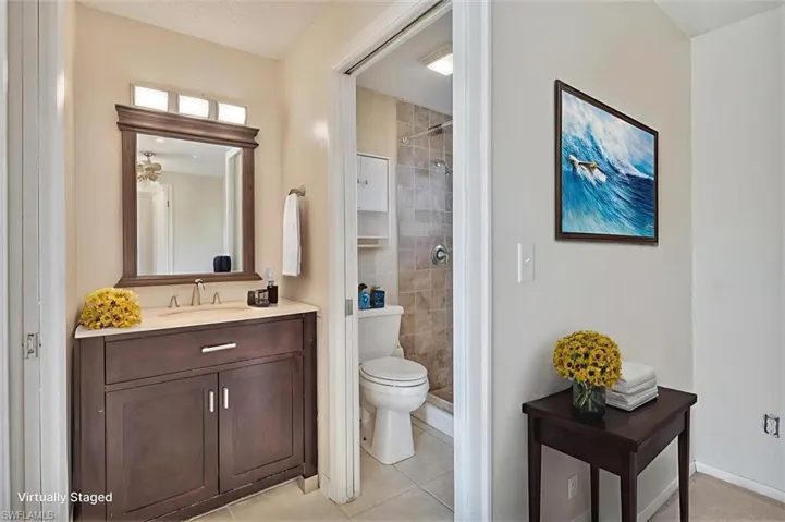 Virtually Staged Full bathroom with vanity, a shower stall, and light tile patterned floors