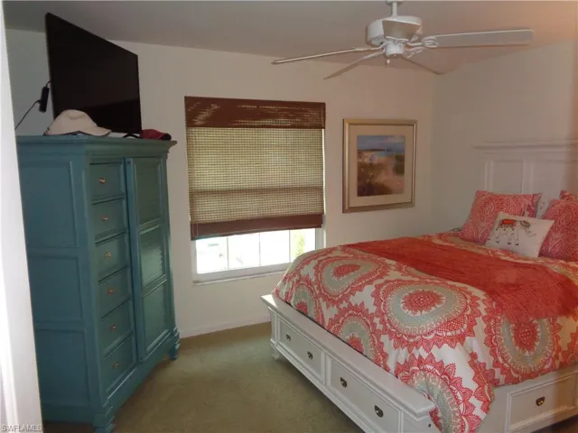Bedroom featuring light carpet and ceiling fan