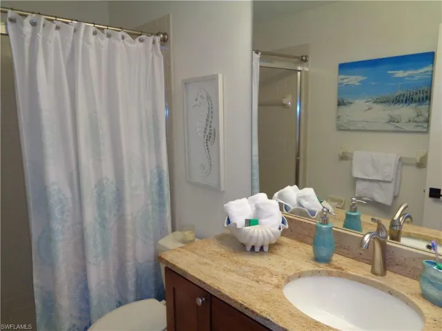 Full bathroom featuring vanity and a shower with shower curtain