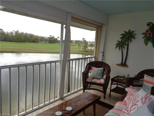 Sunroom / solarium featuring a water view