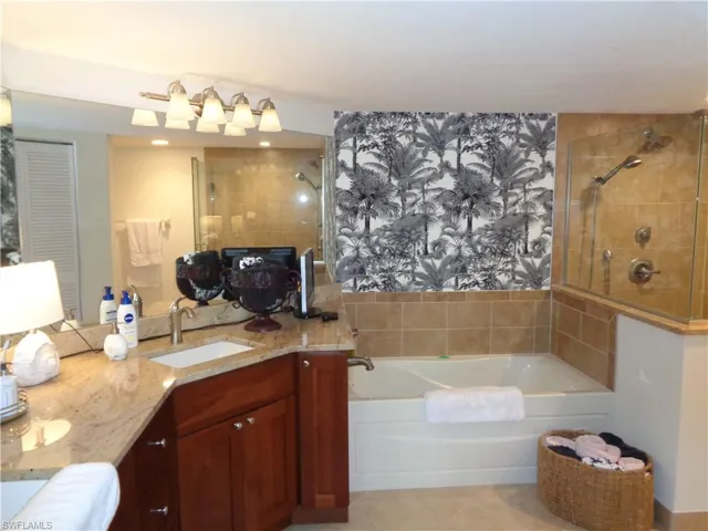 Full bathroom featuring a bath, vanity, tile patterned floors, and a tile shower