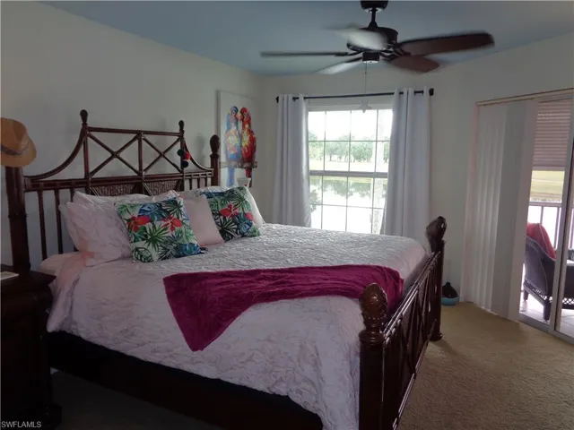 Bedroom featuring carpet, ceiling fan, and access to outside