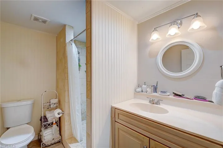 Bathroom featuring ornamental molding and vanity