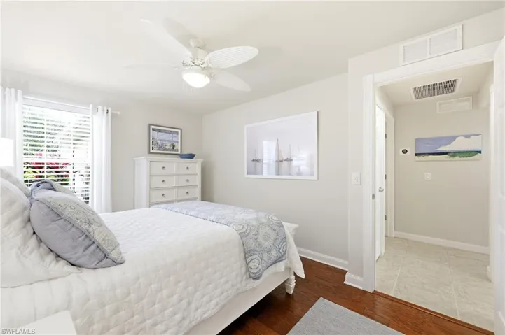 Guest Bedroom with Wood Flooring