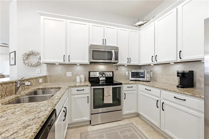 Kitchen with Granite Countertops and stainless stell appliances.
