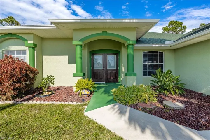 Entryway with nicely landscaped flowerbeds