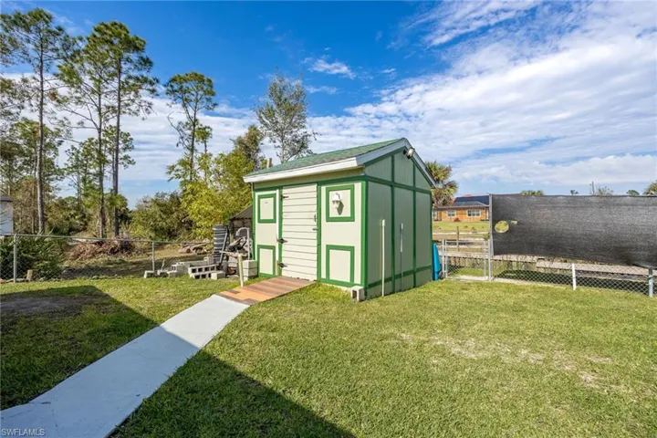 View of outbuilding with a yard