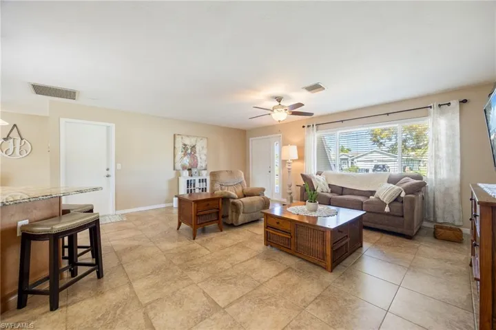 Living room featuring baseboards and ceiling fan