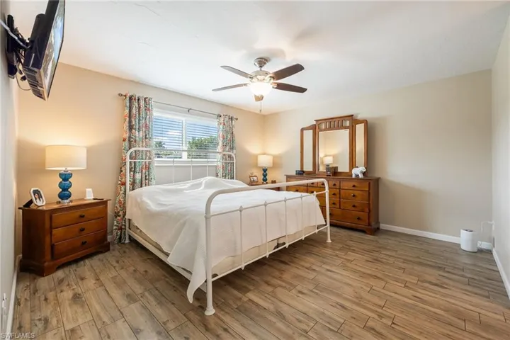 Bedroom featuring wood finished floors and a ceiling fan