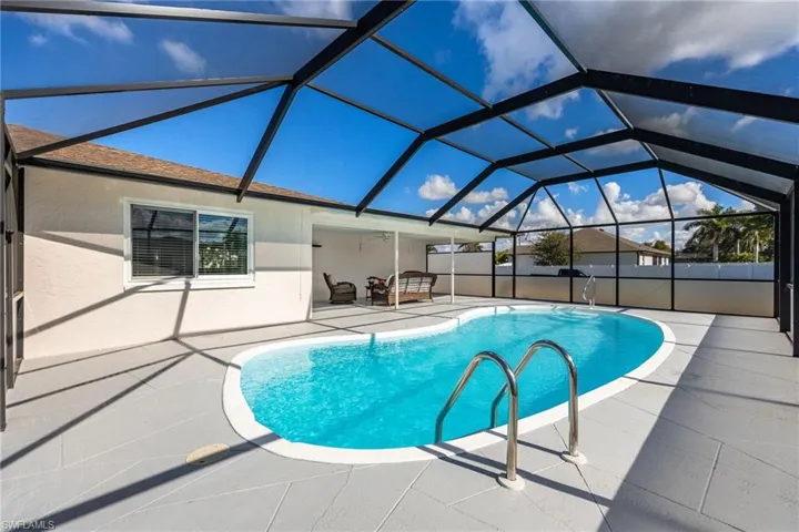 View of pool featuring a lanai, a patio, and a sunroom