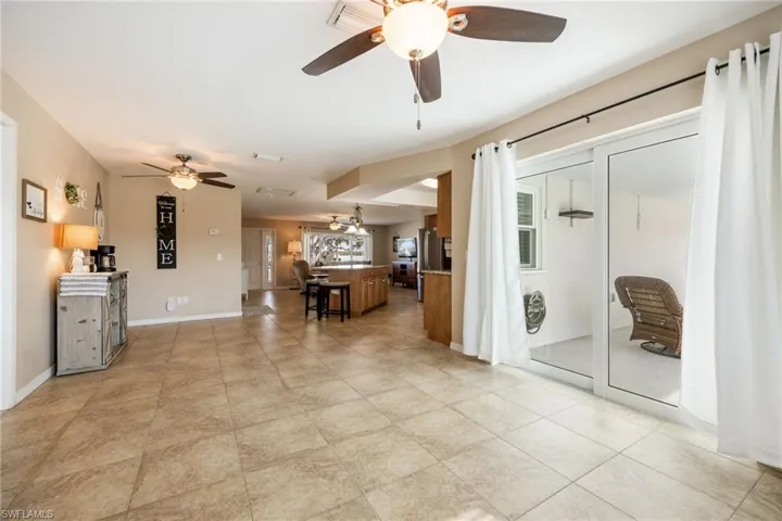 Living room with baseboards and a ceiling fan