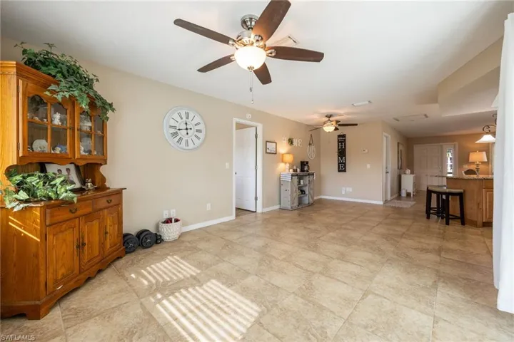 Living room with baseboards and ceiling fan