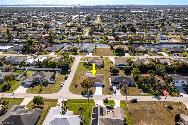 Aerial overview of property's location featuring nearby suburban area and a large body of water