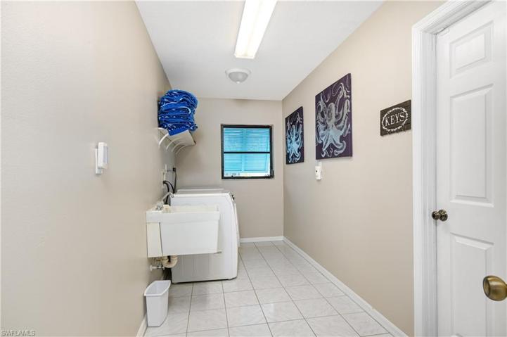 laundry room off the garage area with plenty of room to add cabinets and more storage