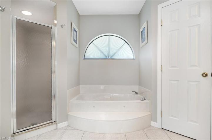 Jetted tub, shower, and plenty of light coming in