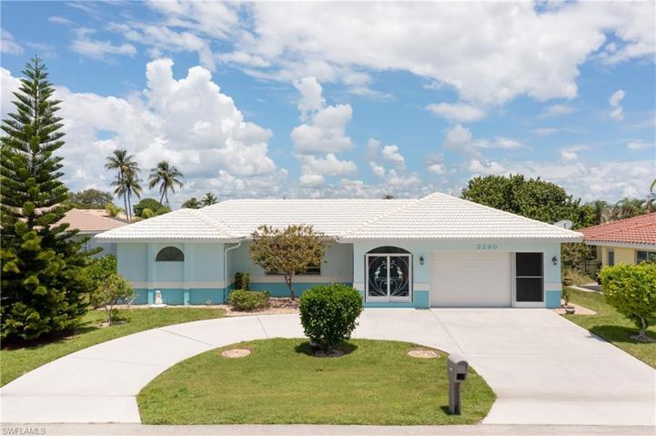 New paint, extra parking, screened entrance, 2 car garage, and mature landscaping