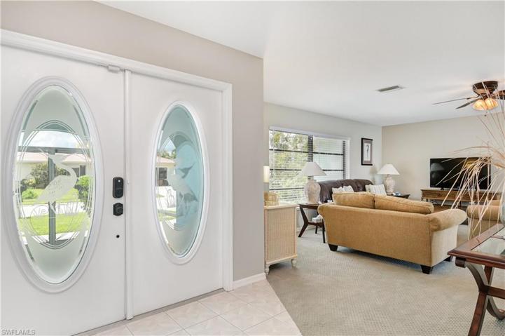 Large entry into living area with double doors - living area and dining near primary bedroom and another living area with eat-in kitchen off the kitchen near other two bedrooms