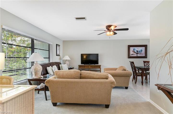 Living area and dining - desk area near entrance- large windows allow natural light