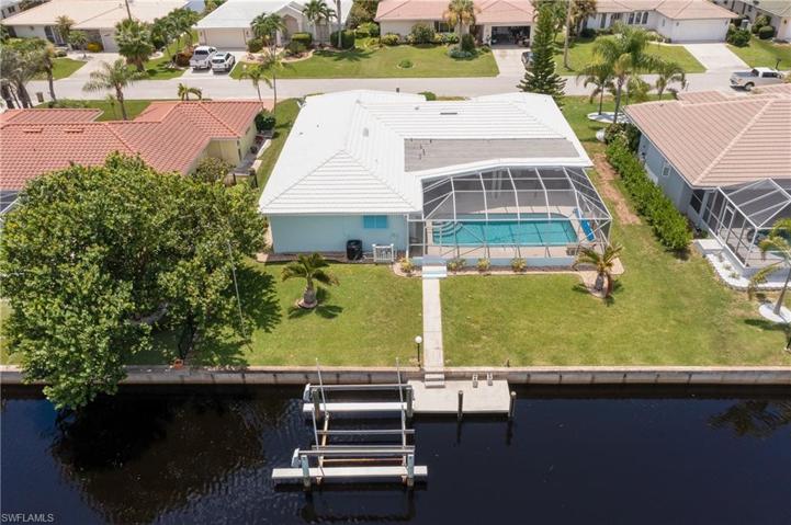 plenty of green space in the backyard, boat dock, lift, and screened in pool