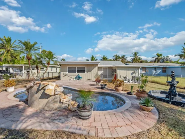 View of pool with a patio and a jacuzzi