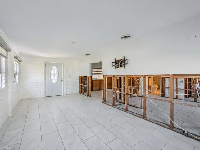 Entryway featuring brick wall