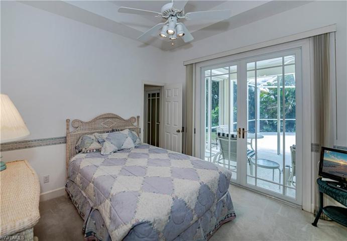 guest bedroom #2 en-suite looking out to the lanai and bathroom entrance