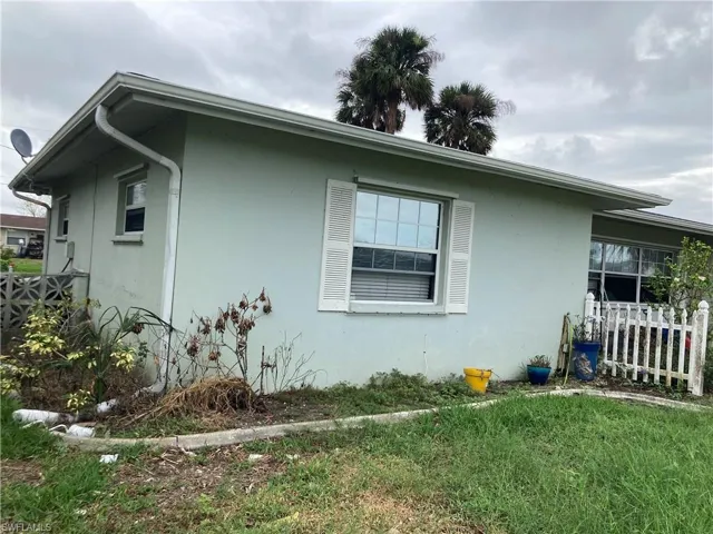 View of side of property with a yard
