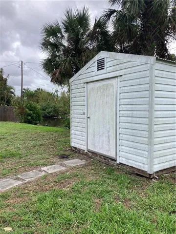View of outbuilding featuring a yard