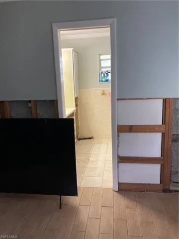 Corridor with light hardwood / wood-style flooring