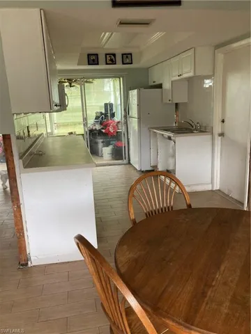 Dining space featuring wood-type flooring and sink