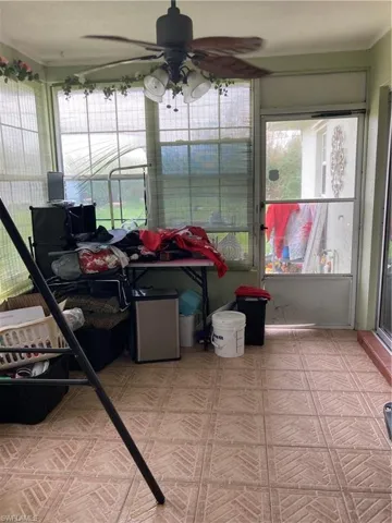 Sunroom / solarium with a healthy amount of sunlight and ceiling fan
