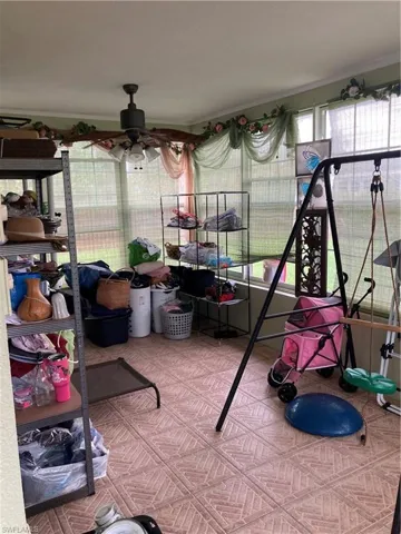 Sunroom / solarium featuring ceiling fan