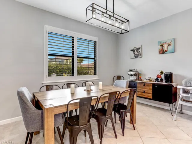 Dining room featuring light tile patterned floors and a chandelier