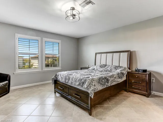 Bedroom with light tile patterned flooring