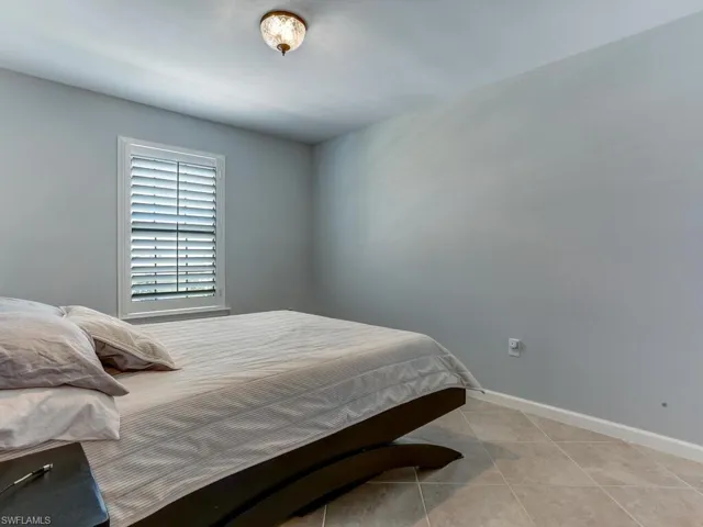 Bedroom with light tile patterned flooring
