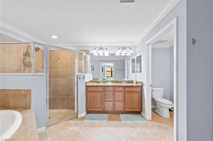Primary bathroom with double sink, walk-in shower and tub