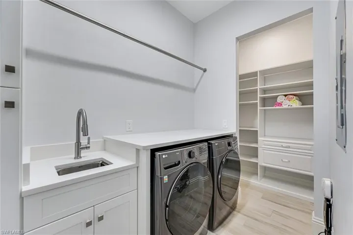 Laundry room with sink and shelving