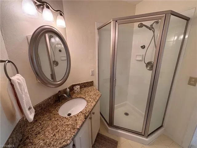 Primary Ensuite with walk in shower and granite counter surface