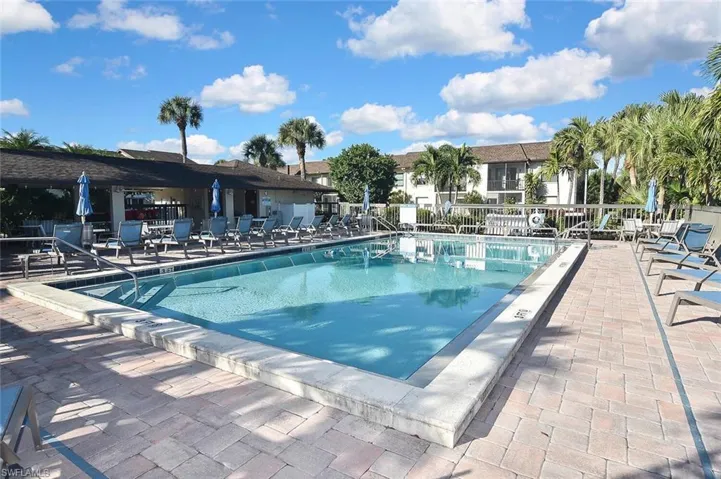Community pool featuring a large pool deck