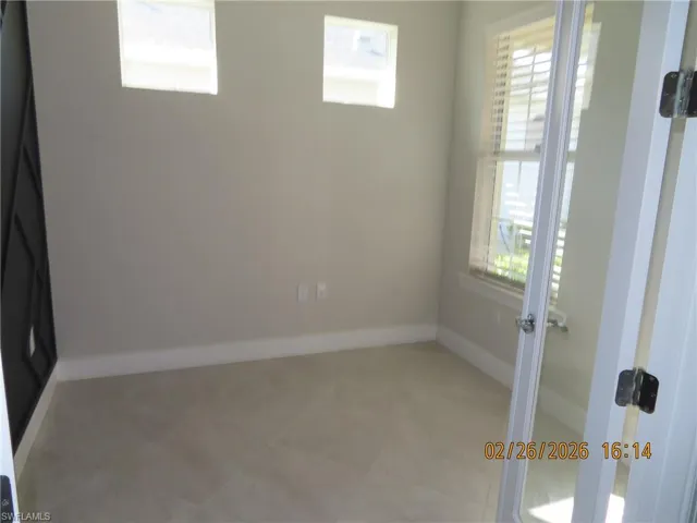 Unfurnished room featuring baseboards and light tile patterned floors