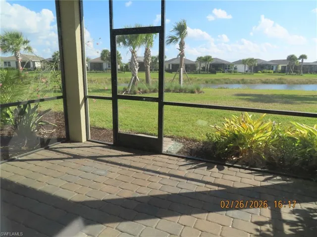 Unfurnished sunroom featuring a residential view and a water view