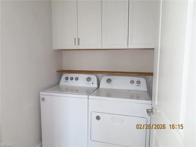 Laundry area featuring washer and dryer and cabinet space