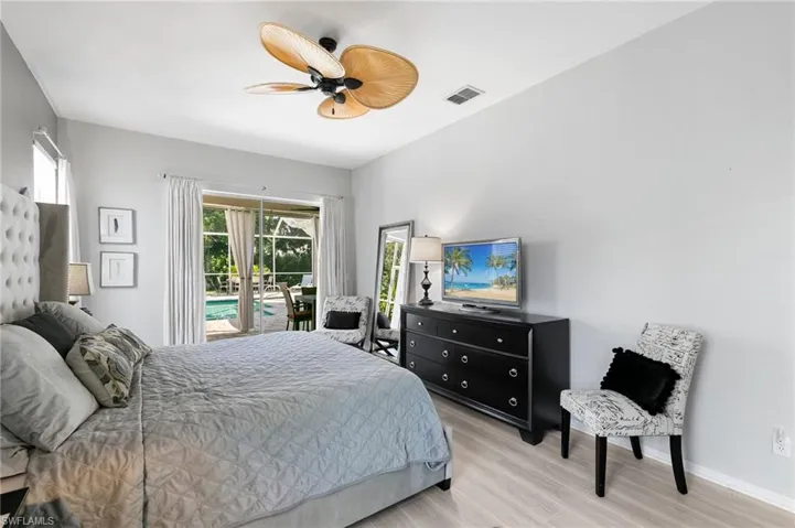 Bedroom with light hardwood / wood-style floors and ceiling fan