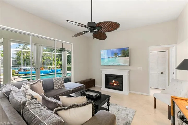 Tiled living room featuring ceiling fan