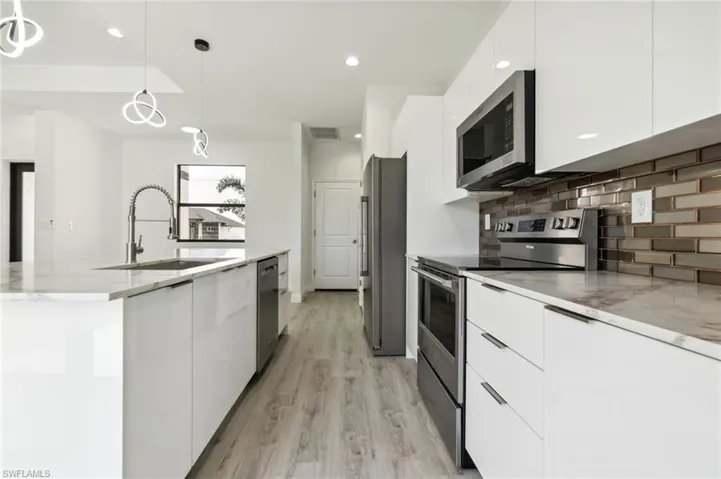 Kitchen with a sink, stainless steel appliances, and modern cabinets