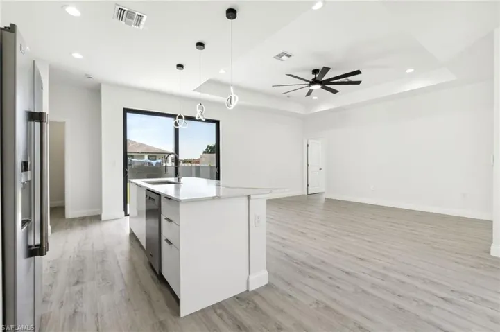 Kitchen featuring a sink, stainless steel appliances, visible vents, recessed lighting, and a raised ceiling
